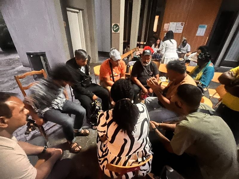 Members of the church sitting in a circle in fellowship after a gathering