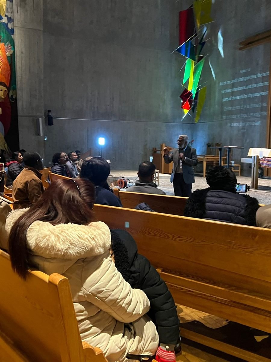 The congregation seated in the sanctuary during a midweek gathering in Geneva